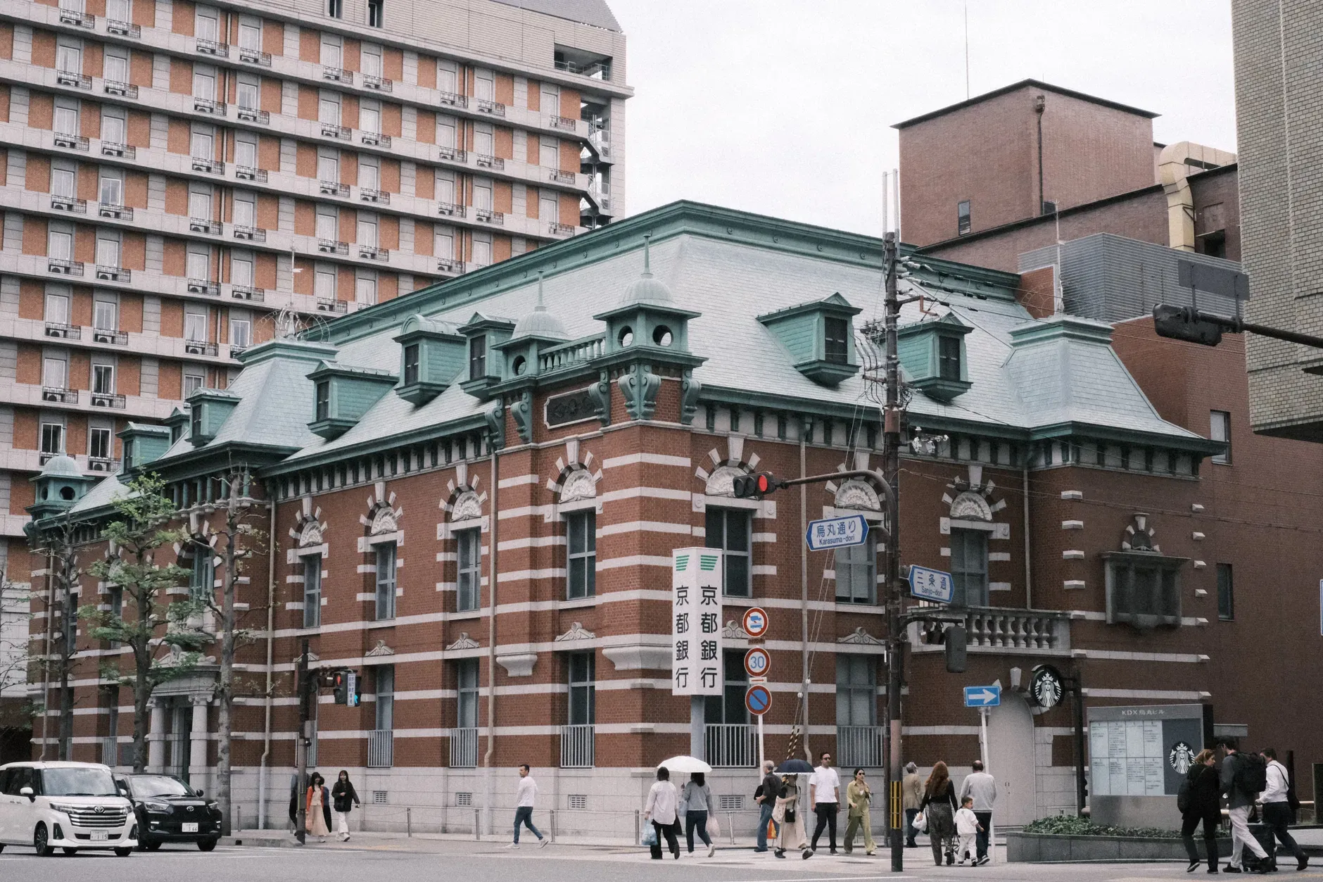 A European-style historic building in a bustling urban area of Kyoto, Japan.